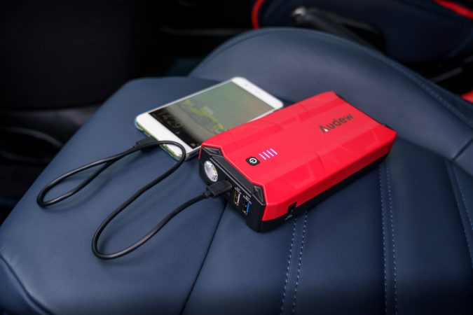 audew car jump starter charging a phone